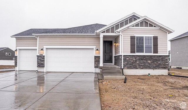 5398 N Pony Rider Way Unit 420, Eagle Mountain, UT 84005 - craftsman-style house with stone siding, board and batten siding, concrete driveway, and an attached garage
