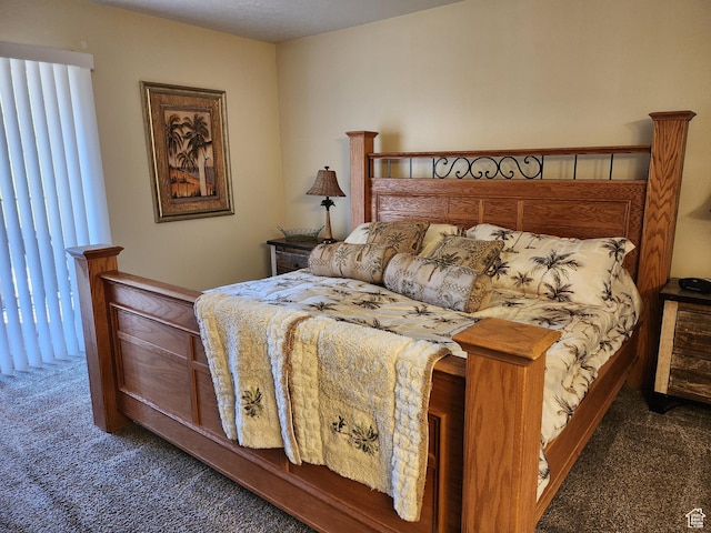 bedroom with dark colored carpet