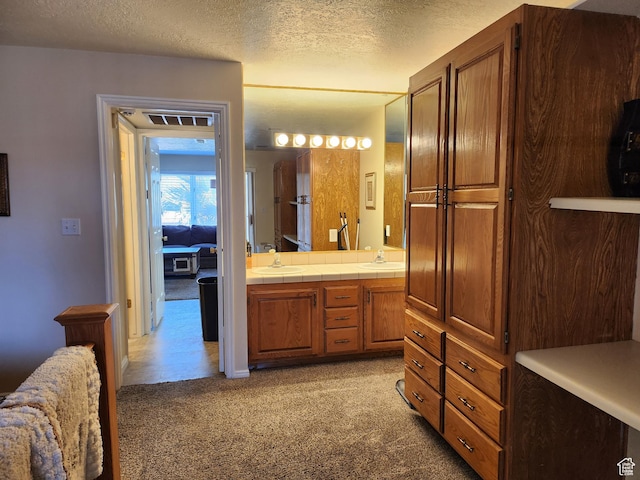 bathroom with vanity and a textured ceiling