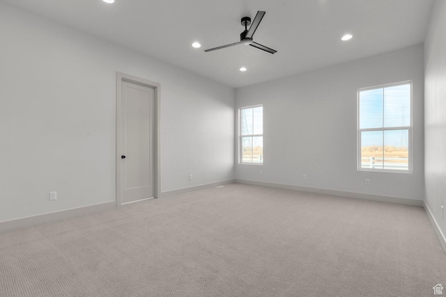 empty room featuring light carpet and ceiling fan