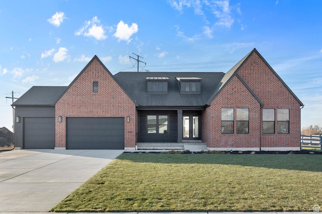 view of front of house with a garage and a front lawn