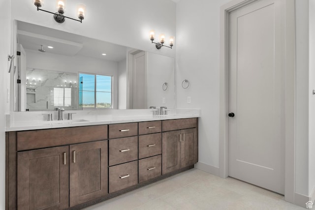 bathroom with vanity and a tile shower