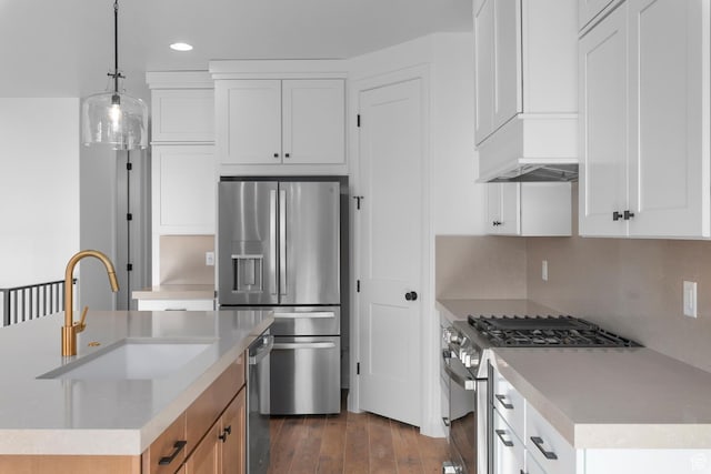 1137 W 2275 S, Syracuse, UT 84075 - kitchen with white cabinetry, an island with sink, sink, hanging light fixtures, and stainless steel appliances