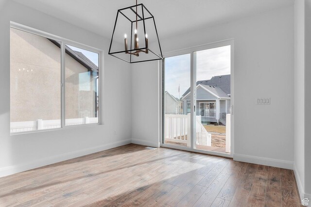 1137 W 2275 S, Syracuse, UT 84075 - unfurnished dining area featuring wood-type flooring and a chandelier
