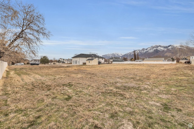 view of yard with fence and a mountain view