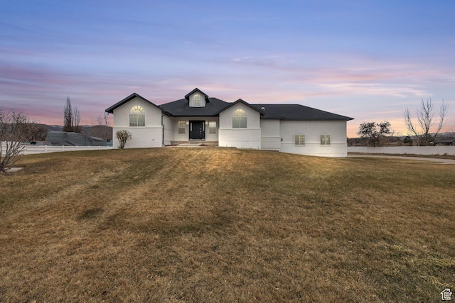 view of front of house featuring a front yard and fence