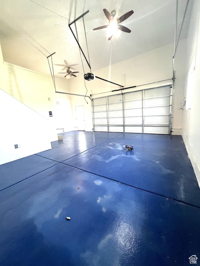 garage featuring a garage door opener and a ceiling fan