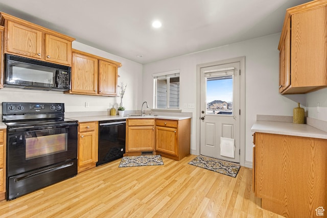 9317 N Prairie Dunes Way, Eagle Mountain, UT 84005 - kitchen with sink, light hardwood / wood-style flooring, and black appliances