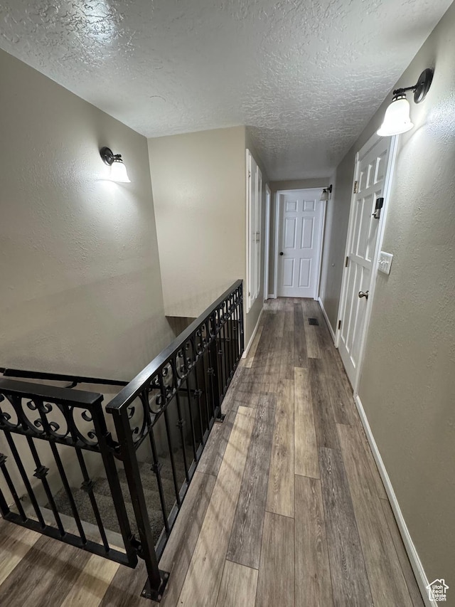 1050 S 500 W, Vernal, UT 84078 - hallway featuring a textured ceiling, wood finished floors, a textured wall, and baseboards