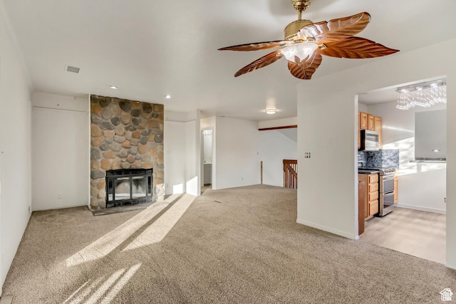 2573 Jordan Meadows Ln, West Jordan, UT 84084 - unfurnished living room with a fireplace, light colored carpet, and ceiling fan