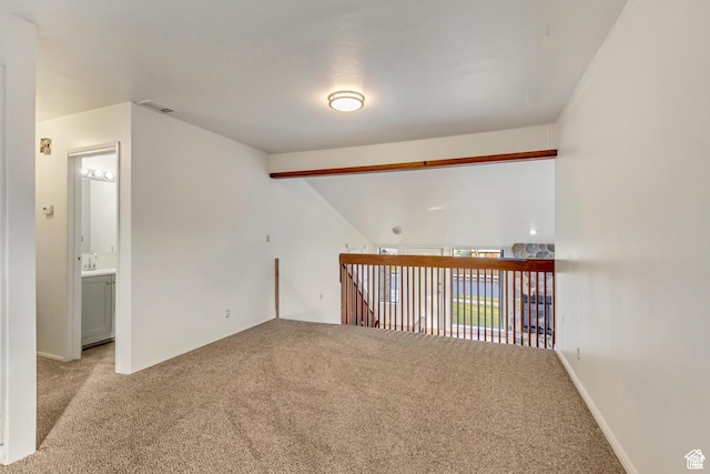 2573 Jordan Meadows Ln, West Jordan, UT 84084 - spare room featuring vaulted ceiling and light colored carpet