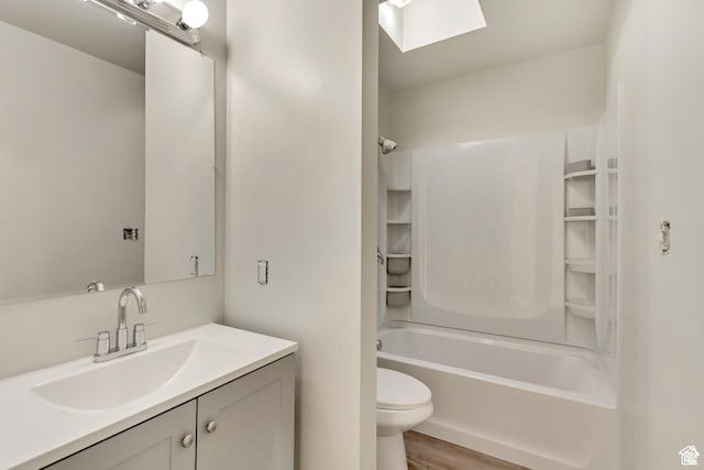 2573 Jordan Meadows Ln, West Jordan, UT 84084 - full bathroom featuring shower / tub combination, hardwood / wood-style floors, a skylight, vanity, and toilet