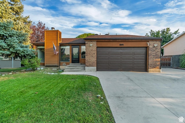 2573 Jordan Meadows Ln, West Jordan, UT 84084 - view of front of home featuring a garage and a front yard