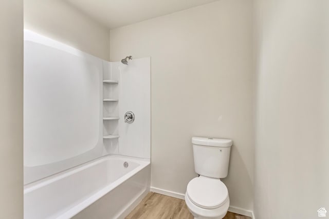 2573 Jordan Meadows Ln, West Jordan, UT 84084 - bathroom with hardwood / wood-style floors, toilet, and washtub / shower combination
