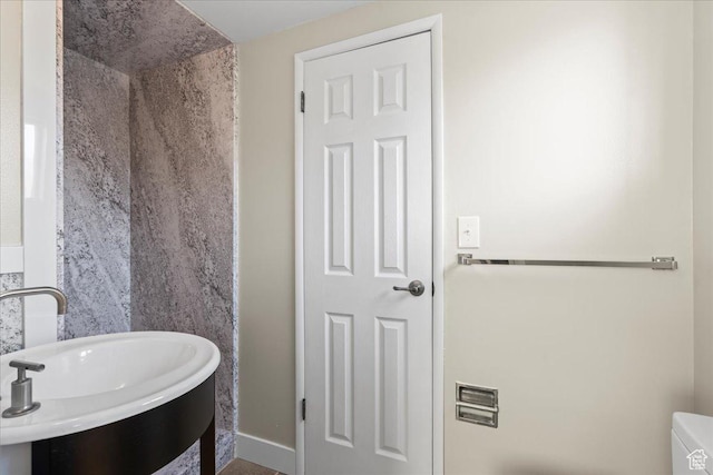 bathroom featuring sink and toilet