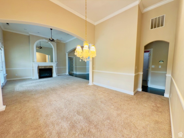 1839 E River Bottom Rd, Springville, UT 84663 - unfurnished living room with ceiling fan, crown molding, carpet floors, a fireplace, and arched walkways