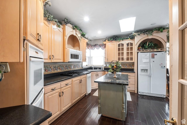 1839 E River Bottom Rd, Springville, UT 84663 - kitchen featuring white appliances, a skylight, dark countertops, light brown cabinets, and glass insert cabinets