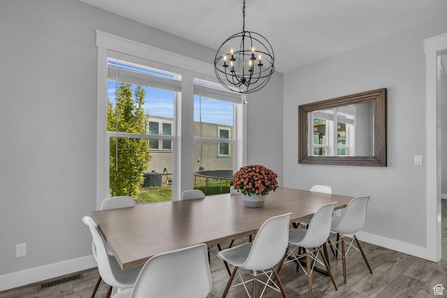 1932 W 200 N, Kaysville, UT 84037 - dining space with a healthy amount of sunlight, a chandelier, and light hardwood / wood-style flooring