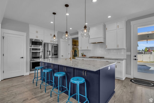 1932 W 200 N, Kaysville, UT 84037 - kitchen featuring pendant lighting, an island with sink, white cabinets, stainless steel appliances, and custom range hood