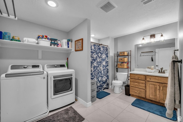 1932 W 200 N, Kaysville, UT 84037 - laundry room featuring sink, washing machine and dryer, a textured ceiling, and light tile patterned floors