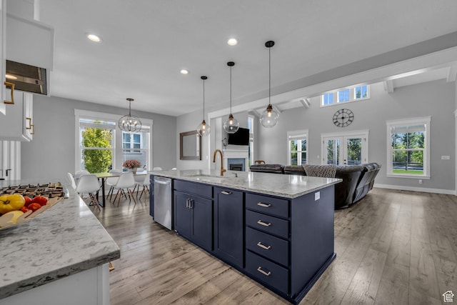 1932 W 200 N, Kaysville, UT 84037 - kitchen featuring blue cabinets, sink, decorative light fixtures, an island with sink, and stainless steel appliances