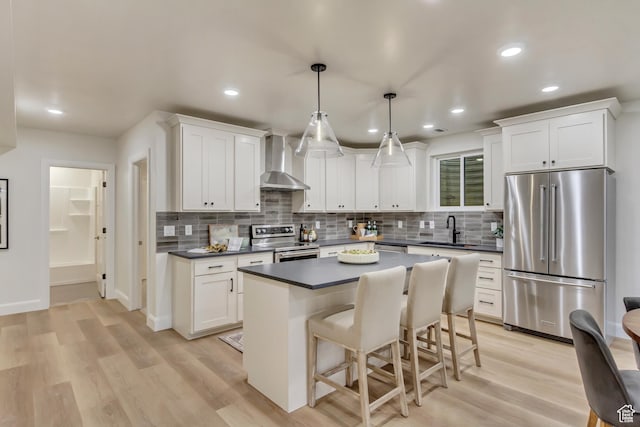 909 W 1180 N, Pleasant Grove, UT 84062 - kitchen featuring stainless steel appliances, wall chimney exhaust hood, a sink, dark countertops, and recessed lighting