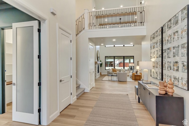 909 W 1180 N, Pleasant Grove, UT 84062 - hall featuring a towering ceiling, light wood finished floors, stairway, and baseboards