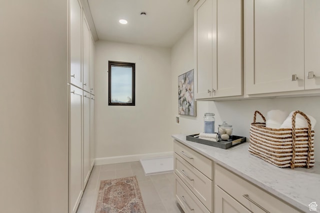 909 W 1180 N, Pleasant Grove, UT 84062 - laundry area featuring cabinet space, light tile patterned floors, recessed lighting, and baseboards