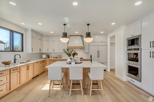 909 W 1180 N, Pleasant Grove, UT 84062 - kitchen featuring custom range hood, built in appliances, light wood-type flooring, backsplash, and recessed lighting