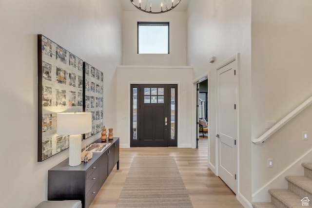 909 W 1180 N, Pleasant Grove, UT 84062 - foyer with healthy amount of natural light, light wood-type flooring, stairs, a towering ceiling, and a chandelier