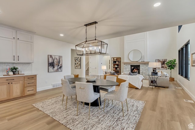 909 W 1180 N, Pleasant Grove, UT 84062 - dining area with light wood finished floors, recessed lighting, baseboards, stairs, and a fireplace