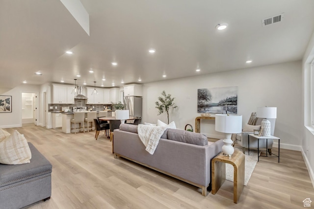 909 W 1180 N, Pleasant Grove, UT 84062 - living room featuring recessed lighting, baseboards, and light wood finished floors