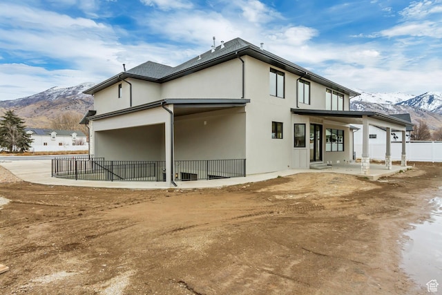 909 W 1180 N, Pleasant Grove, UT 84062 - back of property featuring a patio, a mountain view, fence, and stucco siding