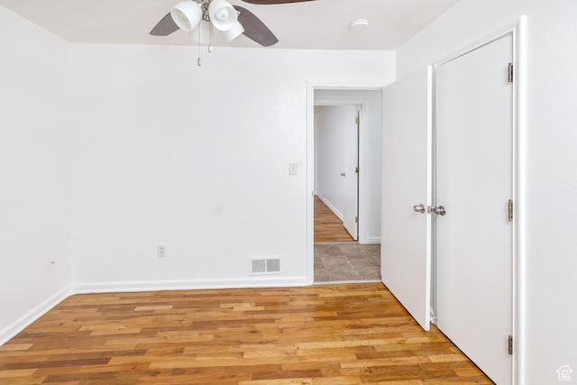 empty room featuring ceiling fan and light wood-type flooring