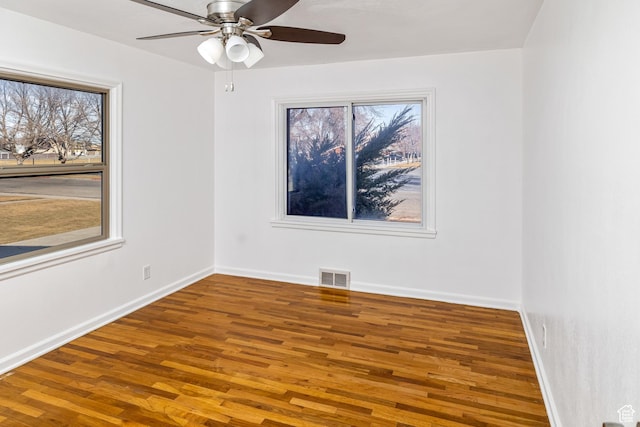 empty room featuring hardwood / wood-style floors and ceiling fan