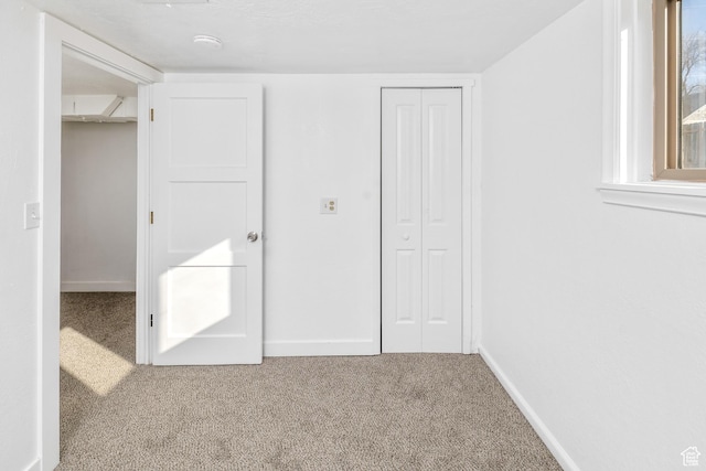 unfurnished bedroom with carpet floors and a closet