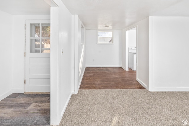 hall with dark colored carpet