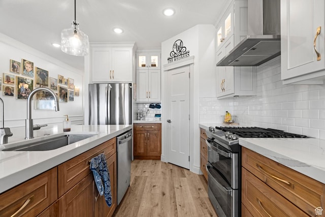 2418 W 4975 N, Cedar City, UT 84721 - kitchen with sink, wall chimney range hood, stainless steel appliances, light stone countertops, and white cabinets