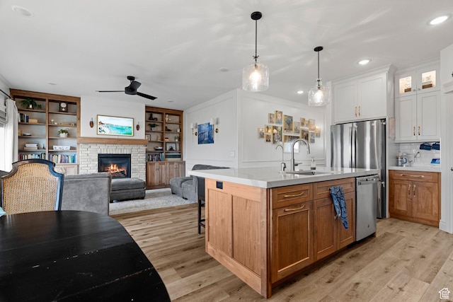 2418 W 4975 N, Cedar City, UT 84721 - kitchen featuring pendant lighting, sink, white cabinets, stainless steel dishwasher, and a center island with sink
