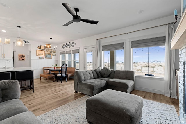 2418 W 4975 N, Cedar City, UT 84721 - living room with sink, ceiling fan with notable chandelier, and light hardwood / wood-style floors