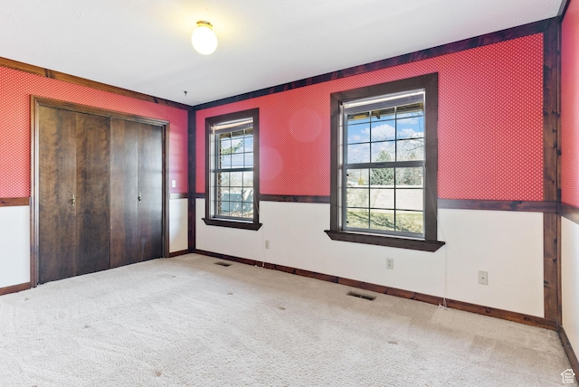 unfurnished bedroom featuring a closet and carpet