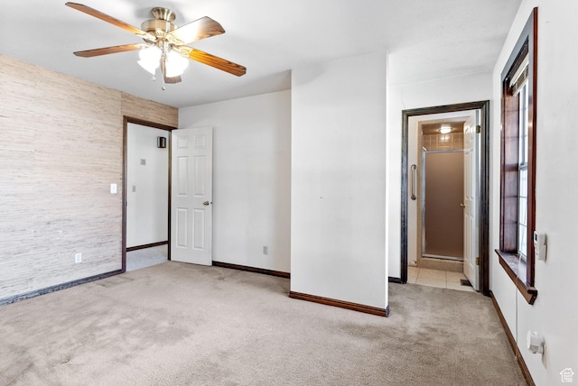 empty room featuring ceiling fan and light carpet