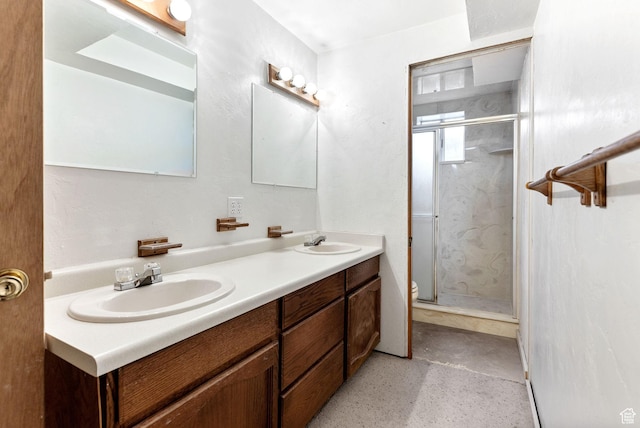 bathroom with vanity, concrete flooring, toilet, and walk in shower