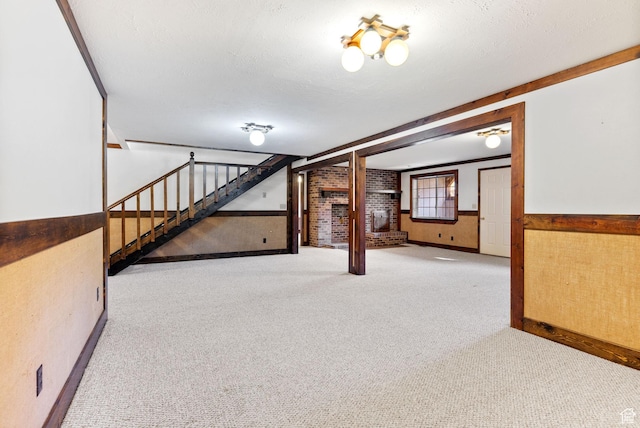 basement featuring brick wall, light carpet, and a textured ceiling