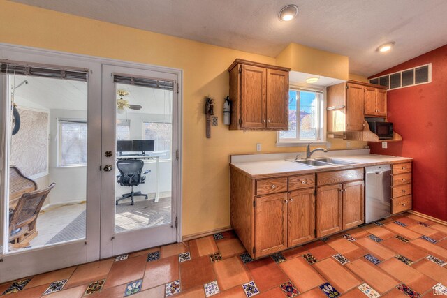 357 W Hobbs St, Moab, UT 84532 - kitchen with stainless steel dishwasher, a sink, brown cabinets, black microwave, and light countertops