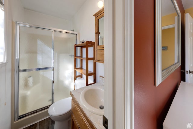 357 W Hobbs St, Moab, UT 84532 - full bathroom featuring vanity, a shower stall, toilet, and wood finished floors