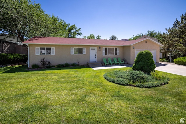 357 W Hobbs St, Moab, UT 84532 - ranch-style home featuring a garage, stucco siding, and concrete driveway