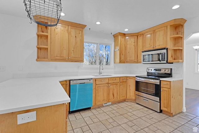 645 N 800 W, Brigham City, UT 84302 - kitchen featuring appliances with stainless steel finishes, light brown cabinetry, sink, and kitchen peninsula