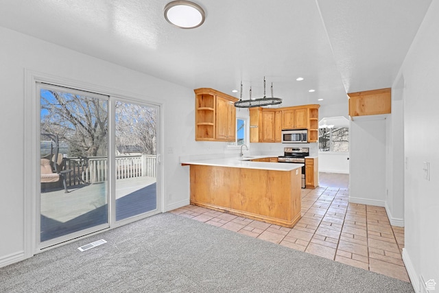 645 N 800 W, Brigham City, UT 84302 - kitchen featuring appliances with stainless steel finishes, sink, kitchen peninsula, light carpet, and a textured ceiling