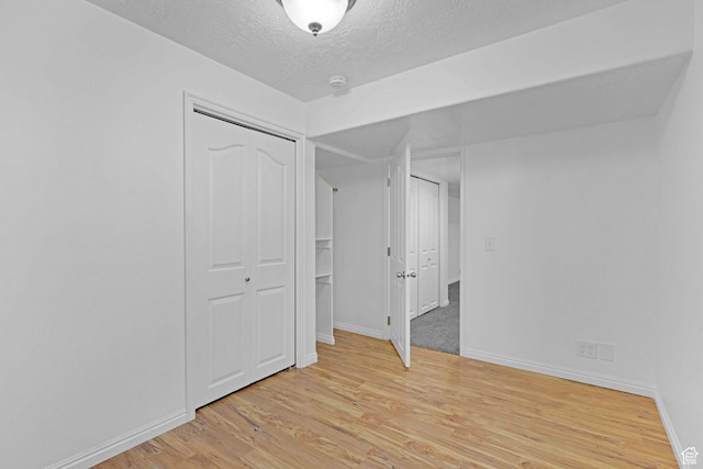 645 N 800 W, Brigham City, UT 84302 - unfurnished bedroom with light hardwood / wood-style floors and a textured ceiling